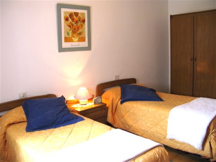 the bedroom has two singel beds and a large wardrobe